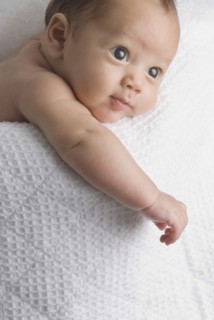Curious baby laying in blanket