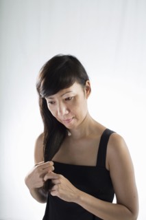 Mixed race woman twisting her hair
