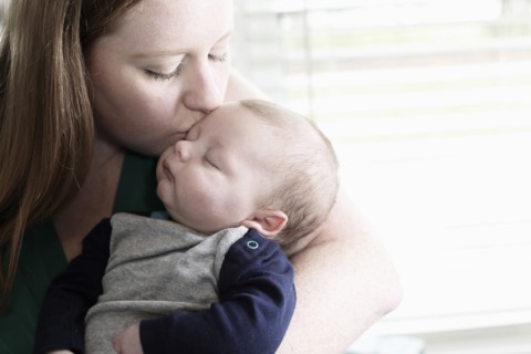 Mother kissing baby son