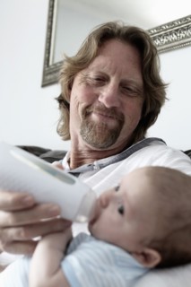 Father feeding baby son