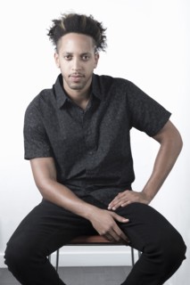 Serious Mixed Race man sitting on chair