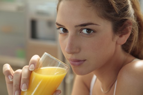 Caucasian woman drinking orange juice