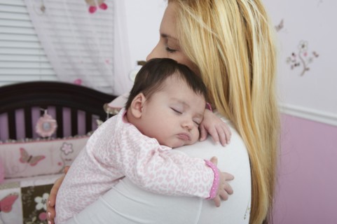 Hispanic mother holding baby daughter