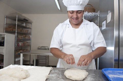 Hispanic baker working in commercial kitchen