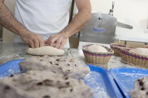 Hispanic baker working in commercial kitchen