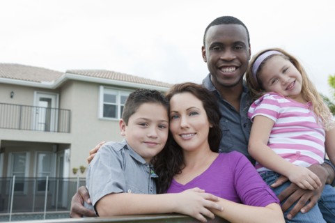Smiling family hugging outdoors