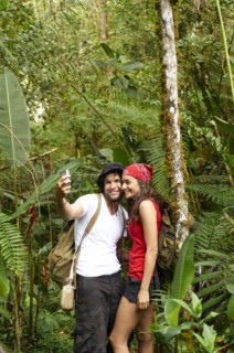 Hispanic couple talking self-portrait in forest