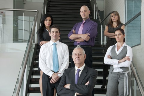 Hispanic business people standing together on staircase