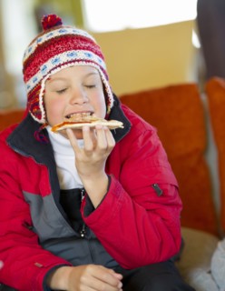 Hispanic boy eating pizza