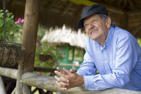 Hispanic man leaning on railing