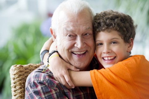 Hispanic boy hugging grandfather