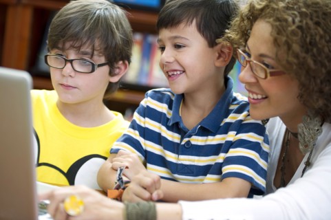Hispanic teacher helping students