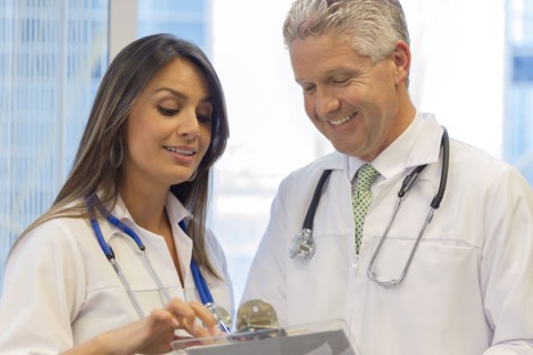 Doctors reading from clipboard