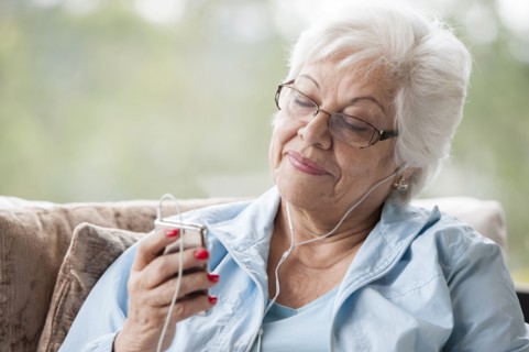 Hispanic woman listening to mp3 player