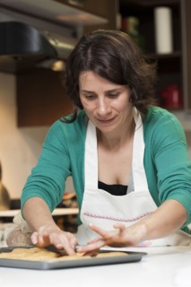 Hispanic woman baking in kitchen