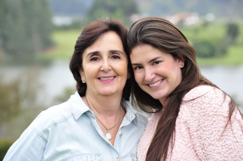 Hispanic mother and daughter smiling together