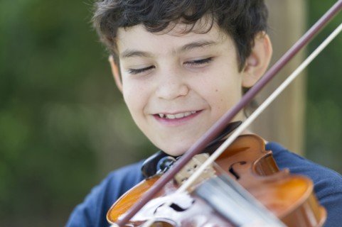 Hispanic boy playing violin