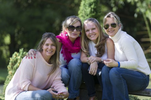 Smiling friends posing outdoors