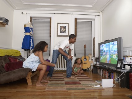 Brother and sister playing video game in living room