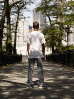 African teenage boy standing in urban park