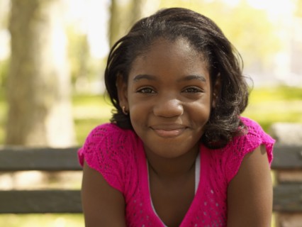 Smiling African girl in park