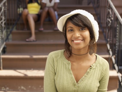 Smiling Hispanic woman with family in background
