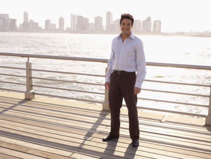 Man standing on boardwalk on waterfront