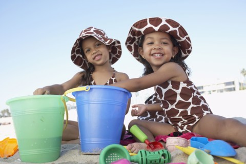 Young mixed race girls playing at beach
