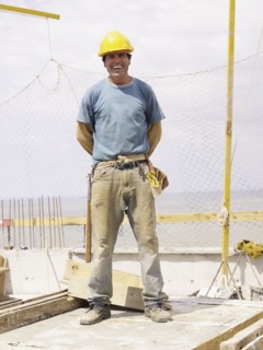 Hispanic worker smiling on construction site