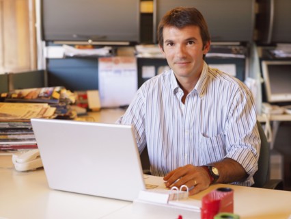 Hispanic businessman sitting at desk