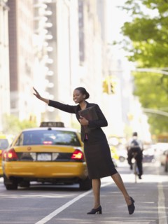 African businesswoman hailing taxi