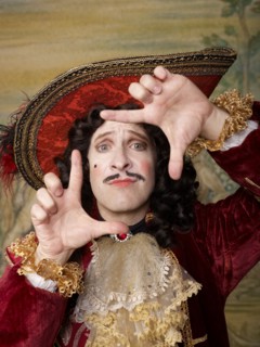 Actor dressed in old-fashioned costume making frame gesture