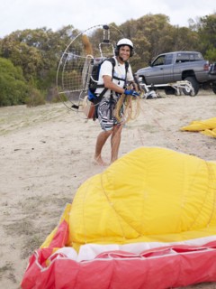 Hispanic man paragliding