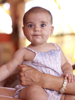 Hispanic grandmother holding baby granddaughter