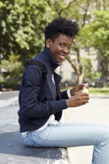 Black woman eating ice cream in park