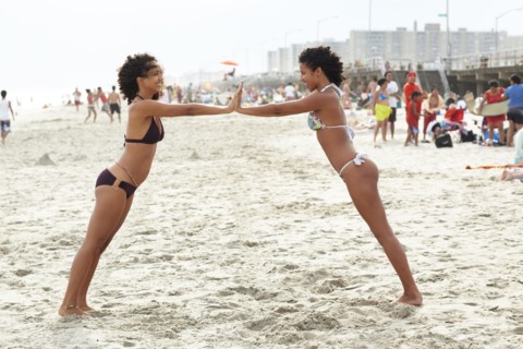 Mixed race friends playing on beach