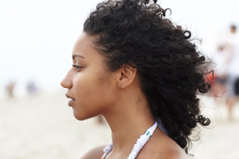 Serious mixed race woman on beach