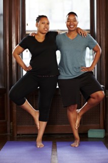 Women balancing together in yoga class