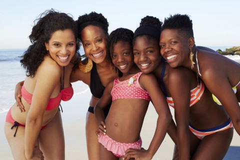 Women smiling together on beach