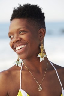 African American woman smiling on beach