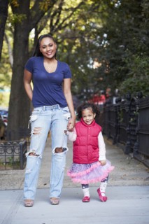 Mother and daughter standing on city street