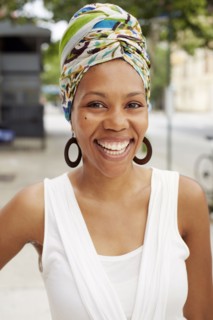 Black woman smiling on city street
