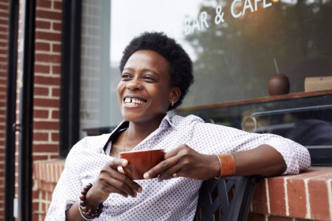 Woman drinking coffee on city street