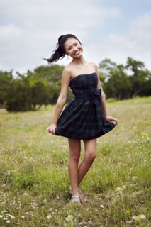Mixed race teenage girl smiling in field