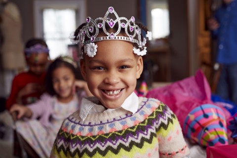 Smiling girl wearing tiara at party