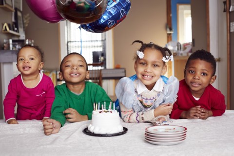 Smiling children with cake at party