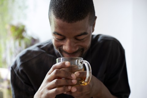 Black man drinking cup of tea