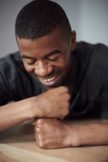 Close up of Black man resting chin on fists