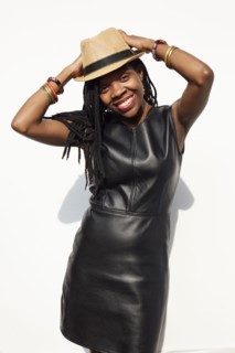 African American woman wearing leather dress and straw hat