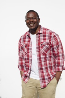 Black man standing with hands in pockets